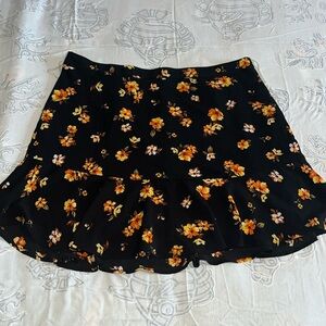 Black mini skirt with warm tone flowers